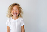 Portrait of a cute kid, girl, laughing, white and neutral teeshirt and background, happiness