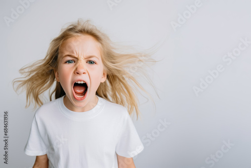 Portrait of a cute kid, girl, screaming, white and neutral teeshirt and background, fear, anger photo