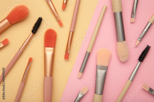 Professional female cosmetics brushes for makeup and eyelash brush on pastel background. Cosmetics concept, make up concept