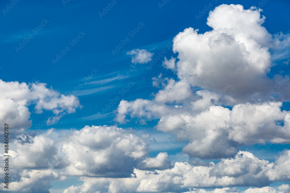 White fluffy clouds and bright sun on dark blue sky.Sky blue or azure sky and clouds is bright white background. White fluffy clouds and bright sun on dark blue sky.Sky blue or azure sky and clouds is bright white background.