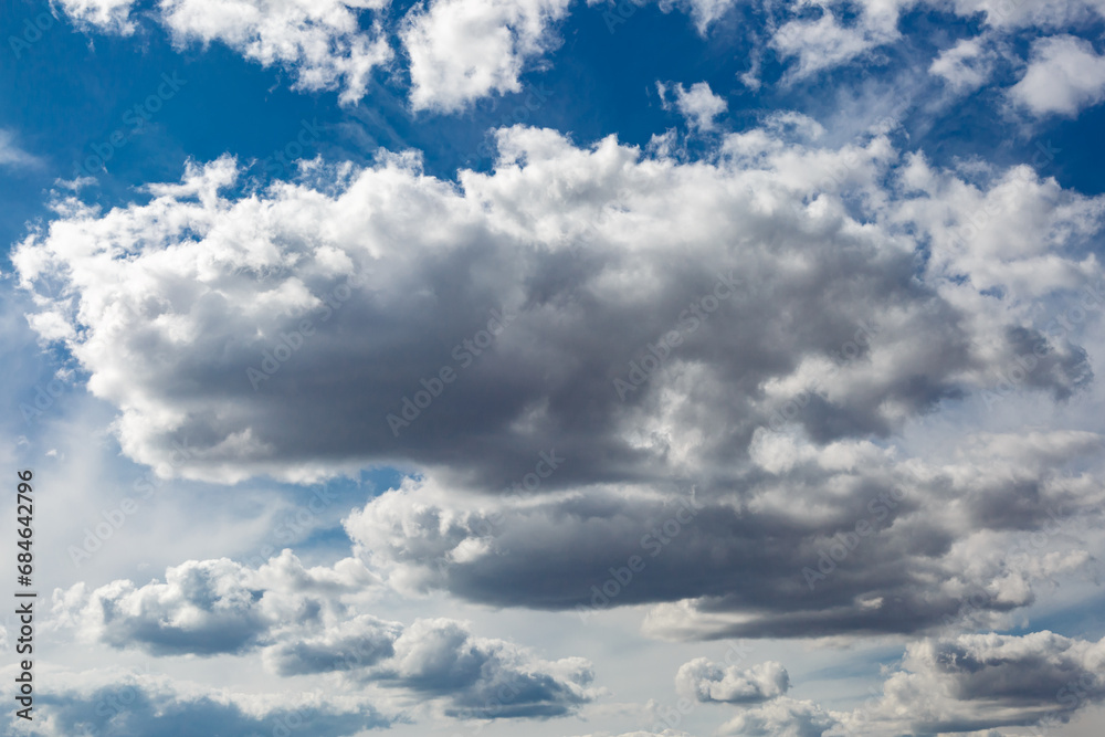 Obraz premium White fluffy clouds and bright sun on dark blue sky.Sky blue or azure sky and clouds is bright white background.