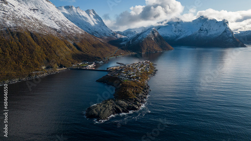 Aerial drone photo of the small island fishing town of Husoy on Senja, Norway.  A fishing village located in the Arctic Circle of Northern Norway.  Shot with a drone. photo
