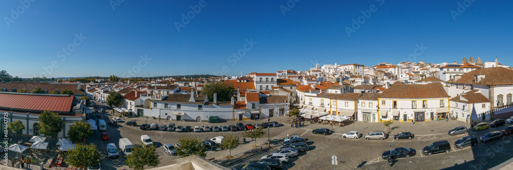 Panoramic view over clay bricks roof tops the with clear blue sky on a sunny day of old town of Evora, Alentejo, Portugal