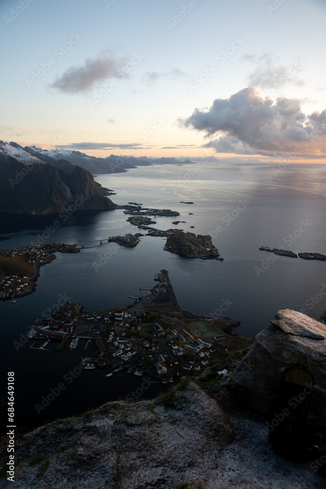 Views from top of Reinebringen mountain hike in Lofoten, Norway.  Snow covered mountains captured on image by a mirrorless camera.  Located far North in the Arctic Circle.  