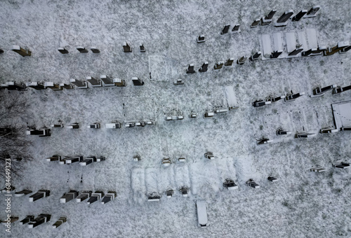 Aerial drone view of the wall and graves of an old abandoned cemetery. inventory of graves and outlines of lost and overgrown positions. archaeological research in practice. meadow with tombstones