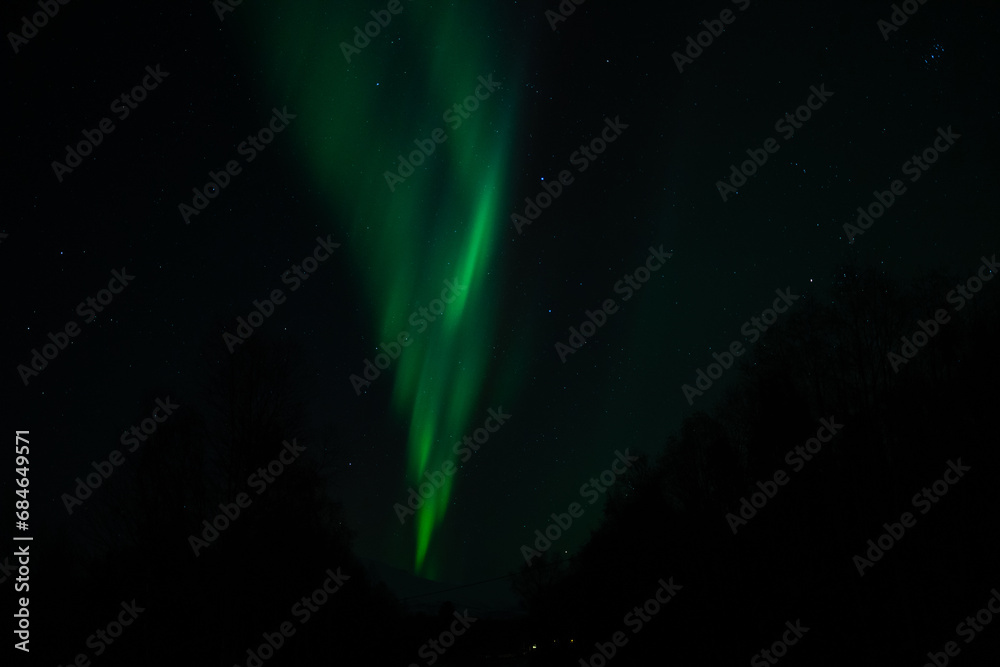 Green Northern Lights Dancing in Arctic skies above Norway. Beautiful