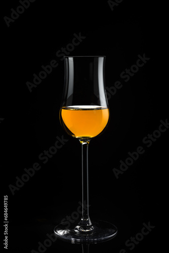 Glass of whiskey on a black background. 