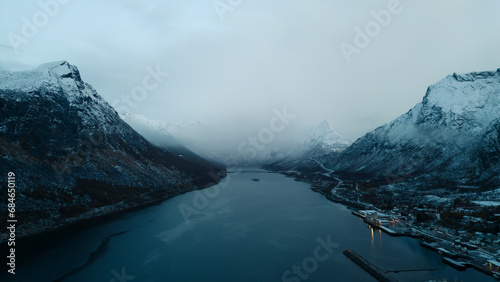 Aerial Drone of Gryllefjord in Lofoten  Norway.  A small fishing village in the Arctic Circle of Northern Norway during the winter months with snow capped peaks and mountains.