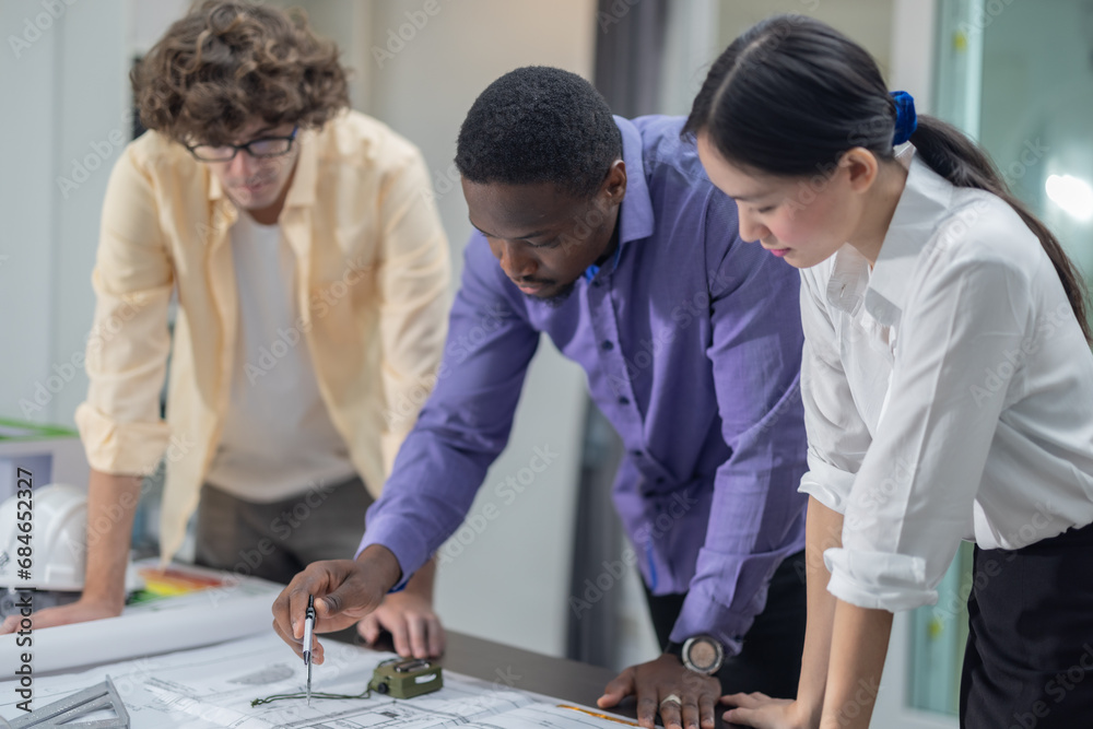 Architects plan low-carbon construction, analyzing blueprint, layout, calculating precise structure Architects plan low-carbon construction, analyzing blueprint, layout, calculating precise structure