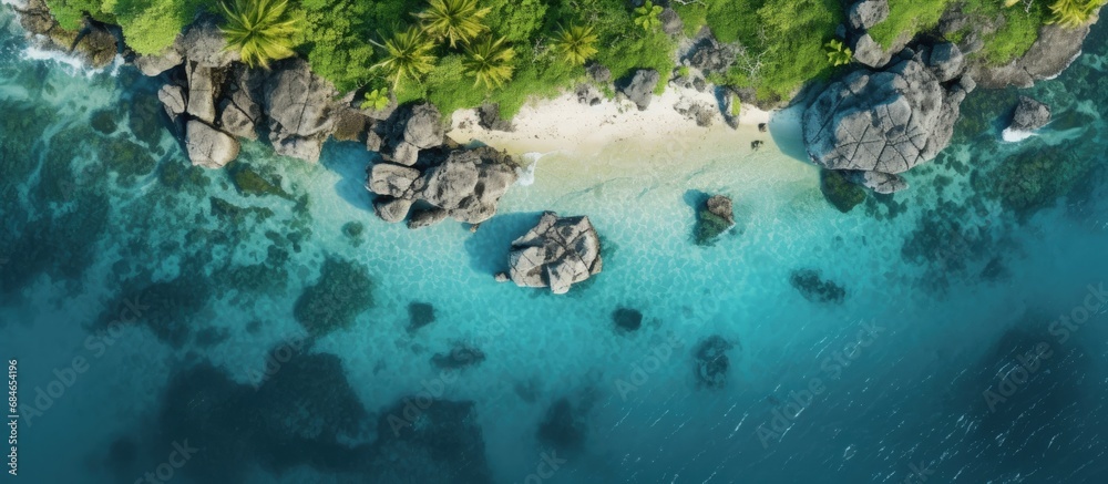 Aerial drone photo of small island with limestone and emerald sea copy space image