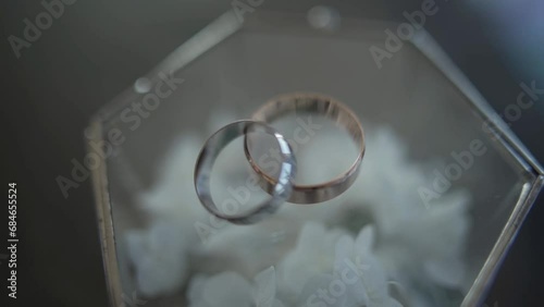 Golden and silver wedding rings lie on the beautiful ring box. Close ou, shift focused footage. photo