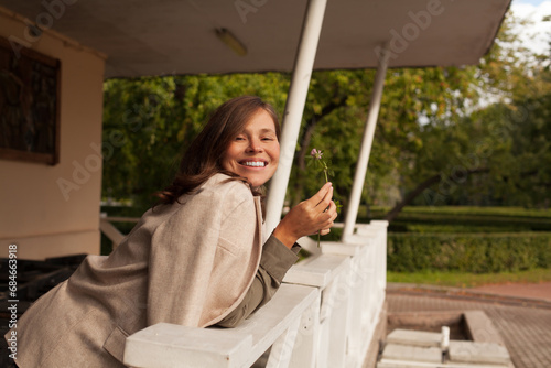 Attractive carefree woman laughing and enjoying sun light outdoor