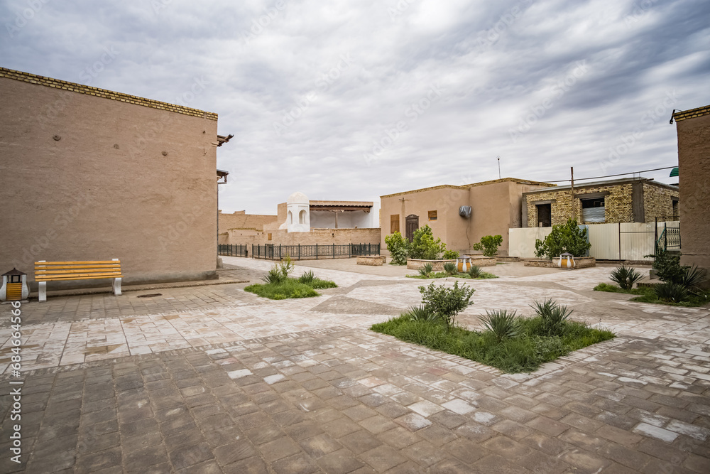 Streets and courtyards with low-rise buildings and development in the ancient city of Khiva in Khorezm, landscaping in Asia
