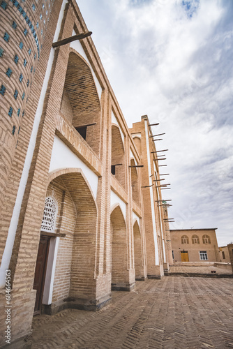 Facade of the historical monument Amir Tura Madrasah with facing in the ancient city of Khiva in Khorezm photo