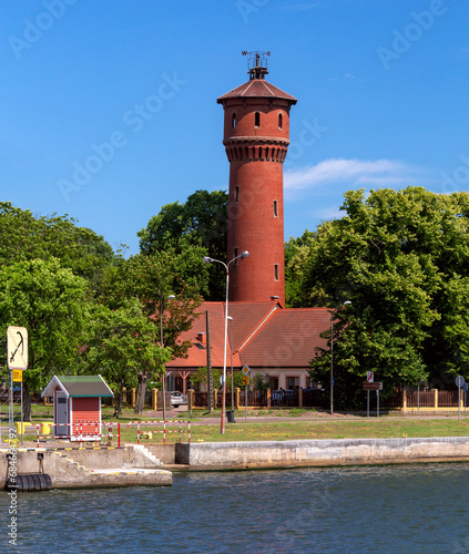 Swinoujscie. Old brick water tower on the bay embankment. photo