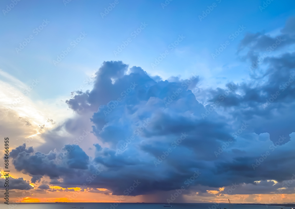 Storm cloud over the sea at sunset