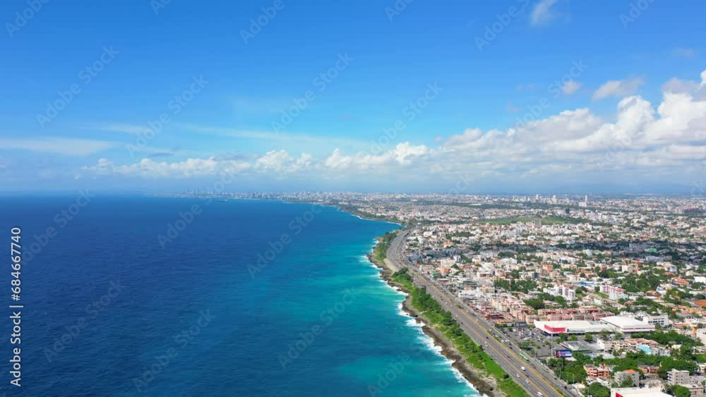 Aerial orbit view of Santo Domingo este. The Autopista Las Americas along the rocky shore of turquoise caribbean sea. Expressway from the Punta Cana to the capital of Dominican Republic Aerial orbit view of Santo Domingo este. The Autopista Las Americas along the rocky shore of turquoise caribbean sea. Expressway from the Punta Cana to the capital of Dominican Republic