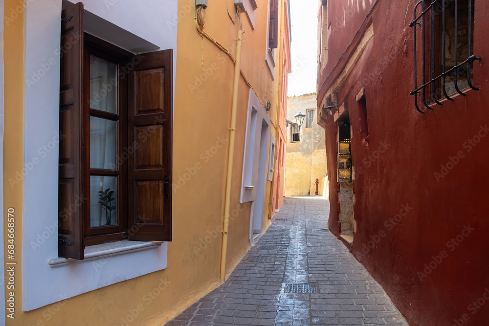 Traditional narrow paved alley between multicolor building. Chania Old Town, Crete island, Greece. Traditional narrow paved alley between multicolor building. Chania Old Town, Crete island, Greece.