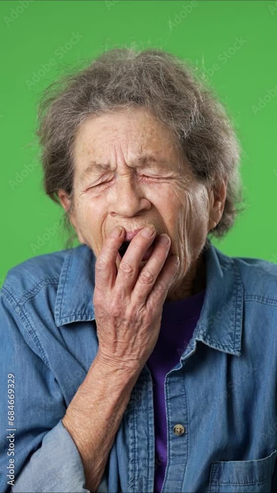 Vertical video portrait of tired, sleepy elderly senior old woman with wrinkled skin and grey hair, isolated on green screen background. Vertical video portrait of tired, sleepy elderly senior old woman with wrinkled skin and grey hair, isolated on green screen background.