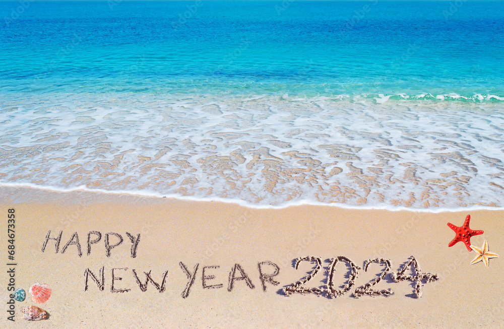 Fototapeta premium happy new year 2024 written on the shore