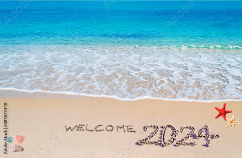 Welcome 2024 written on the sand