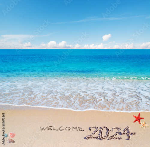 Welcome 2024 written in the sand