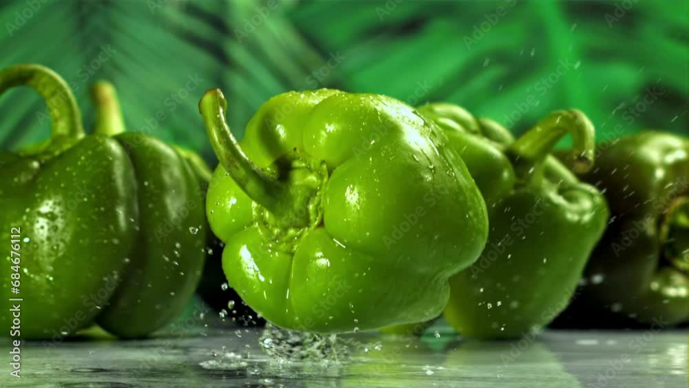 Green sweet pepper falls on a wet board. Filmed on a high-speed camera at 1000 fps. High quality FullHD footage