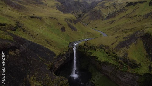 DRONE AERIAL FOOTAGE: Kvernufoss waterfall is located in South Iceland, near the Skogar Cultural Heritage Museum, and cascades down 98 feet (30 meters) from cliffs made of lava rock. photo