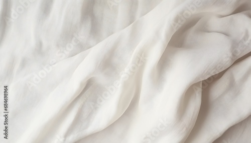 Background of fabric made from natural linen and cotton. Abstract white crumpled linen