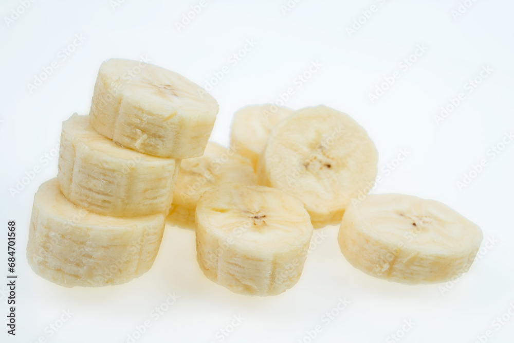 Flying banana slices, isolated on white background.