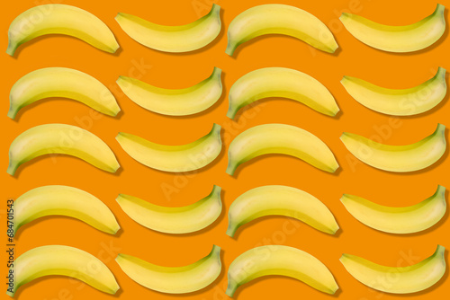 Banana isolated on orange background. Bananas texture design for textiles, wallpaper, fabric.
