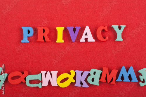 PRIVACY word on red background composed from colorful abc alphabet block wooden letters, copy space for ad text. Learning english concept. photo