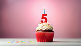Birthday cupcake with lit birthday candle Number five for five years or fifth anniversary