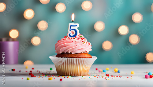Birthday cupcake with lit birthday candle Number five for five years or fifth anniversary photo