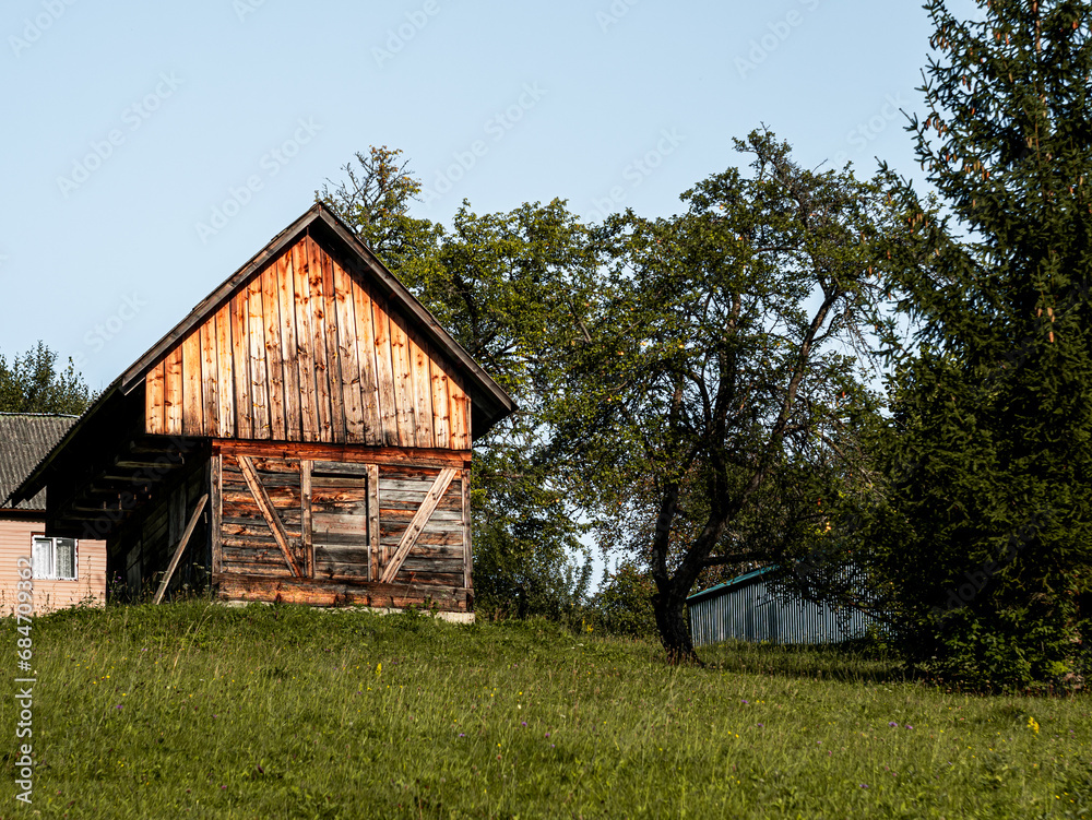 Old authentic wooden house with hayloft in scenic Carpathian mountains Ukraine, Europe, Transcarpathia region. Local countryside travel forest hiking trails. Cottagecore style vacation. Eco tourism.