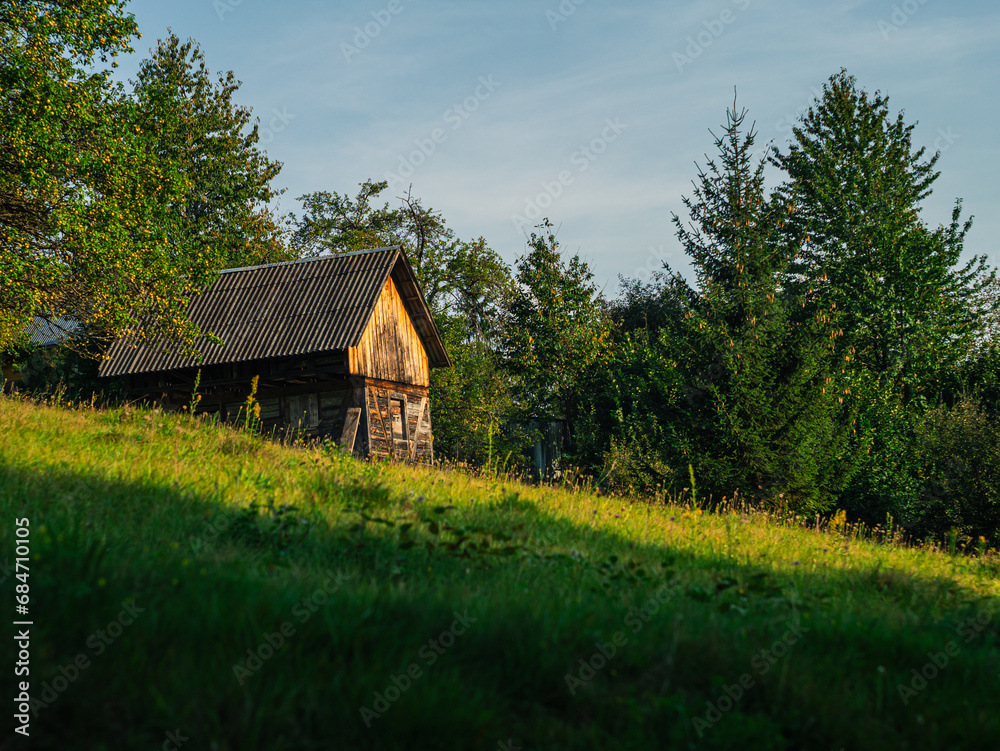 Old authentic wooden house with hayloft in scenic Carpathian mountains Ukraine, Europe, Transcarpathia region. Local countryside travel forest hiking trails. Cottagecore style vacation. Eco tourism. Old authentic wooden house with hayloft in scenic Carpathian mountains Ukraine, Europe, Transcarpathia region. Local countryside travel forest hiking trails. Cottagecore style vacation. Eco tourism.