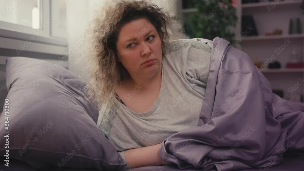 Woman with unhealthy weight staying in bed after wakeup, apathy and loneliness Woman with unhealthy weight staying in bed after wakeup, apathy and loneliness