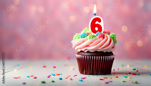 Birthday cupcake with lit birthday candle Number six for six years or sixth anniversary