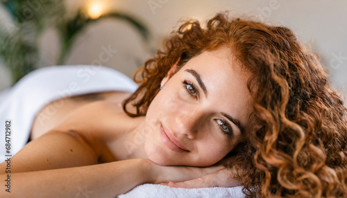 portrait of a relaxed young woman lying in a massage bed