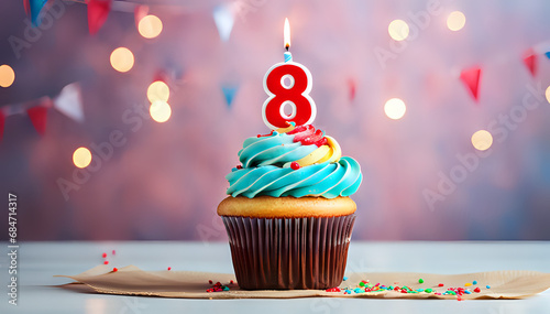 Birthday cupcake with lit birthday candle Number eight for eight years or eighth anniversary photo