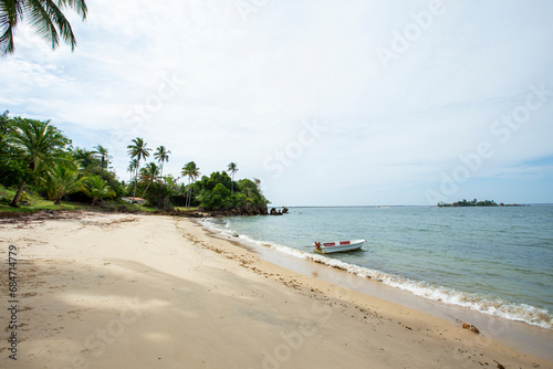Pequeno bote ancorado na margem da praia de uma ilha deserta no litoral do nordeste brasileiro