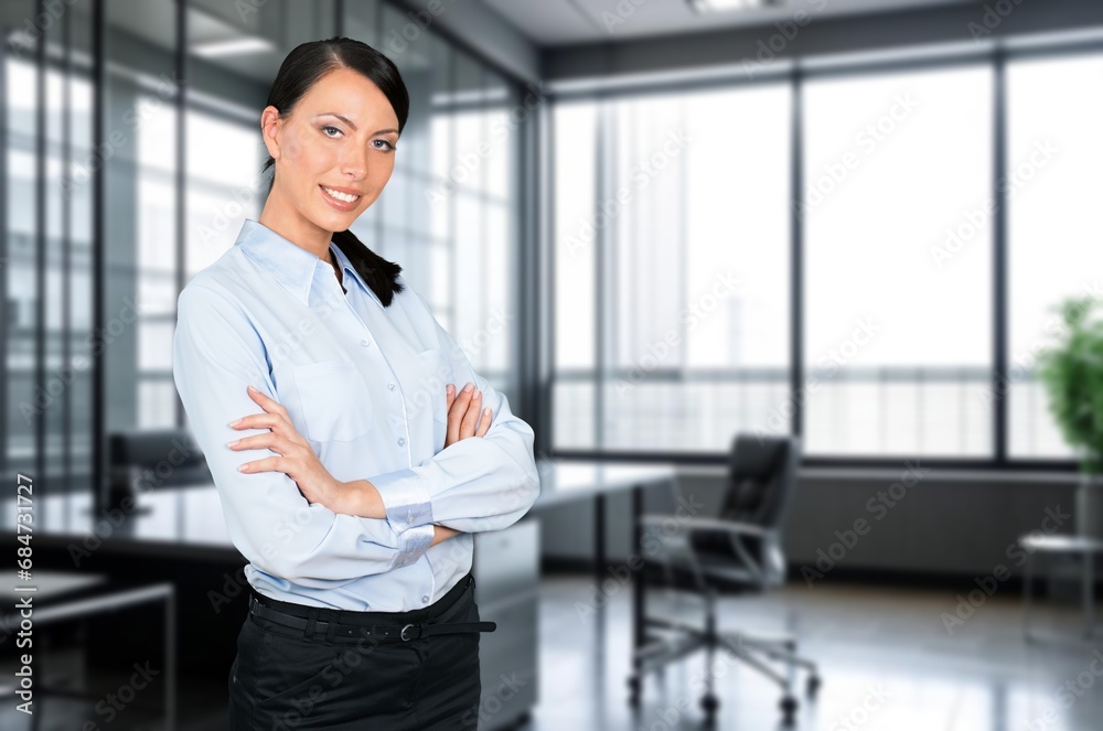 Beautiful business woman smiling at camera in office Beautiful business woman smiling at camera in office