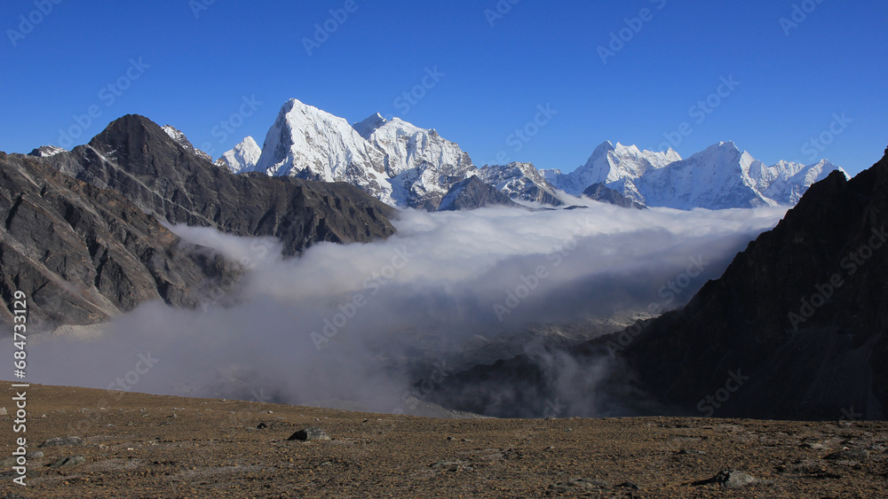 Sea of fog in the Gokyo Valley and snow capped high mountains of the Himalayas, Nepal.