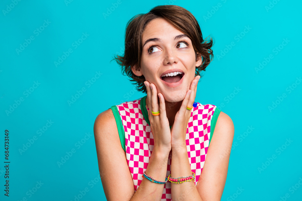 Photo of cute gorgeous girl dressed stylish dress hands touch cheeks looking up banner billboard isolated on cyan color background Photo of cute gorgeous girl dressed stylish dress hands touch cheeks looking up banner billboard isolated on cyan color background