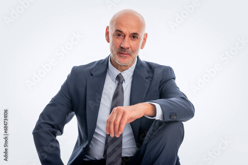 Mid aged businessman wearing suit and tie against isolated background