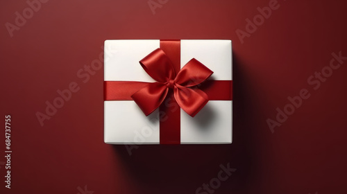 Top view of white christmas gift with red ribbon and bow
