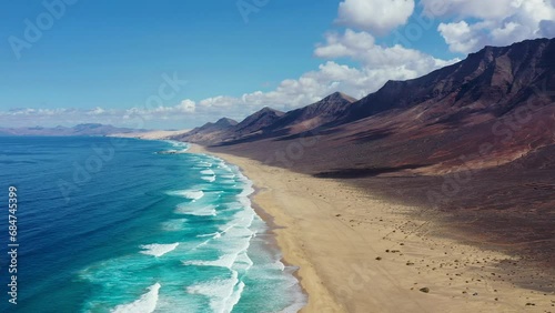 Amazing Cofete beach with endless horizon. Volcanic hills in the background and Atlantic Ocean. Cofete beach, Fuerteventura, Canary Islands, Spain. Playa de Cofete, Fuerteventura, Canary Islands. photo