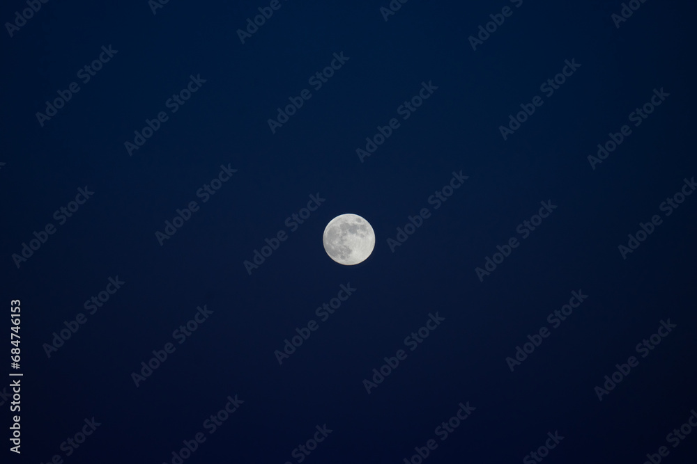 Full moon against a dark blue sky. Full moon against a dark blue sky.