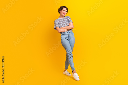 Full length photo of confident lovely girl dressed stylish clothes summer collection isolated on yellow color background photo