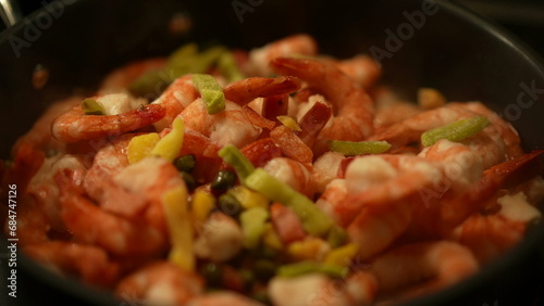 Seafood shrimps inside pan with smoke steam, adding ingredients on top of food preparation